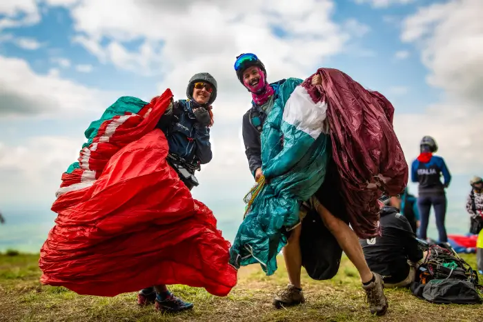 Eva Maranta, Reiseguide von touch and go Paragliding, steht zusammen mit einem Teilnehmer am Startplatz in Kolumbien und bereitet sich auf einen Streckenflug vor.